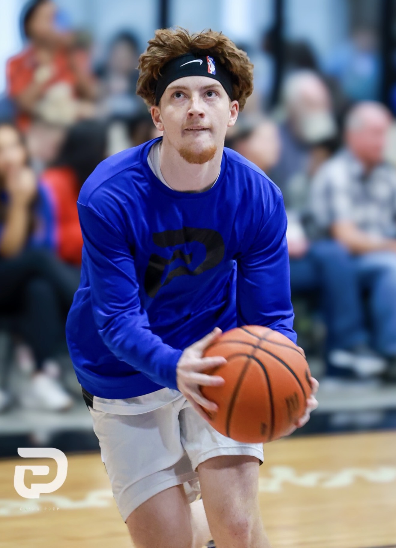 Grind Prep basketball player preparing to shoot in a blue warmup top